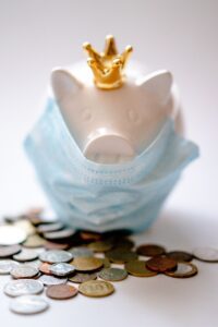 piggy bank with medical mask and coins